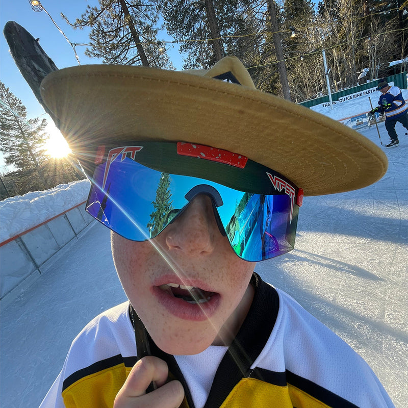 / Z87+ Blue | imagine_how_nice_it_will_look_on_you.JPG | Kid in a hockey rink wearing Pit Viper Sunglasses