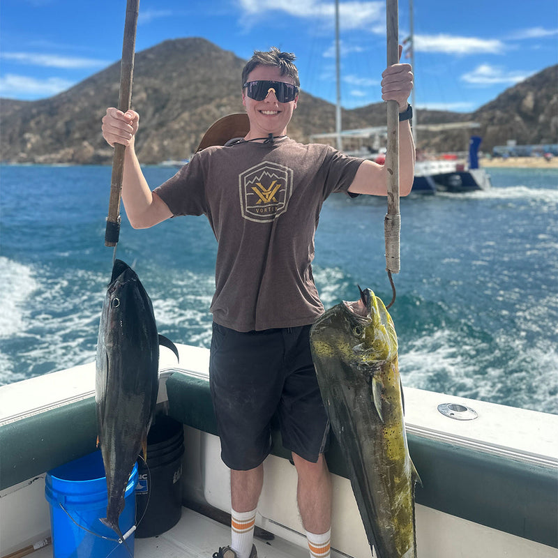 Polarized Smoke / Narrow | thats_why_i_took_all_these_photos.JPG | Boy holding two big fish wearing The Naples Original from Pit Viper Sunglasses