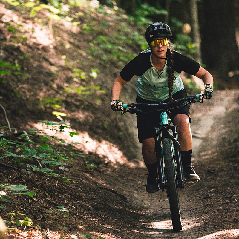 Polarized Orange / Narrow | photo_of_person.JPG | Woman riding a mountain bike wearing The Monsterbull Original from Pit Viper Sunglasses