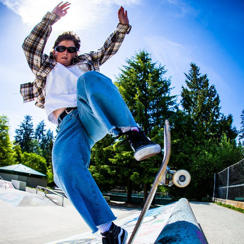 /Smoke | photo_of_person_2.JPG | Woman skateboarding wearing Pit Viper Sunglasses